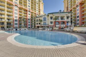 a large swimming pool in front of some apartment buildings at Emerald Grande Condo Beach, Marina and Ocean View in Destin