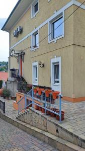 a house with orange benches in front of it at Andy's Apartman in Budapest