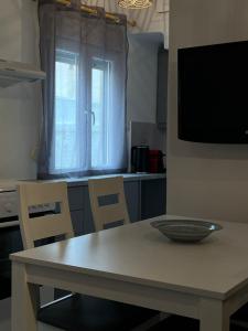 a kitchen with a table with a bowl on it at Thèros in Ermoupoli