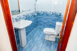 a bathroom with a toilet and a sink at Golden View Guest in Ella