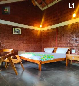 a large bed in a room with two benches at Chalobahills Farmstay Resort in Ajra