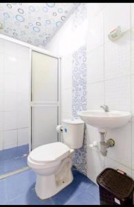 a bathroom with a toilet and a sink at Hostal Cartagena Beach in Cartagena de Indias