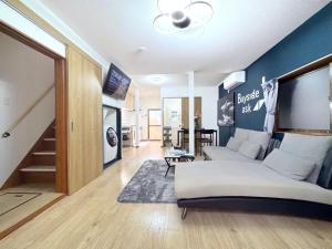 a bedroom with a bed and a living room at guesthouse Chikko - Vacation STAY 15111 in Osaka