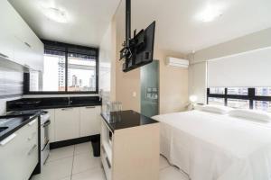a kitchen with white appliances and a large window at Classic Golden Point - Boa Viagem in Recife