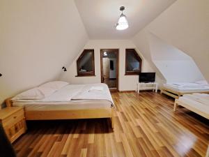 a bedroom with a bed and a desk in it at Tatry Panorama in Zakopane