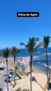 a view of a beach with palm trees and the ocean at Ondina Apart Hotel - Apto 419 in Salvador