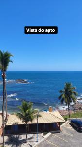 a view of the ocean from a parking lot with palm trees at Ondina Apart Hotel - Apto 419 in Salvador