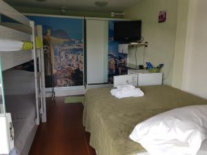 a bedroom with two bunk beds and a window at Pousada Miami in Rio de Janeiro