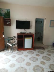 a living room with a flat screen tv and a chair at Bedouins Inn Village in Aqaba