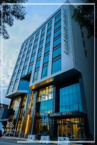 a large building with glass windows in front of it at Sargali Duhok Hotel in Duhok