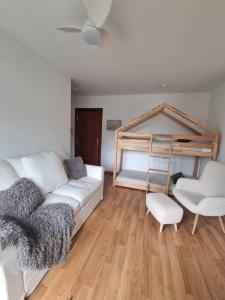 a living room with a white couch and a bunk bed at La Casina Del Alce in Aller +52 photos
