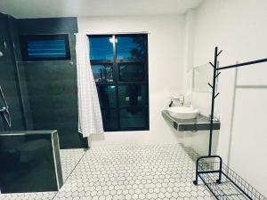 a bathroom with a shower and a sink and a mirror at Sky View Home and Hostel Chiangmai in Chiang Mai