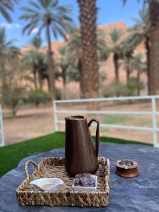 a tea kettle sitting on a tray on a table at Five caravan in Al-ʿUla