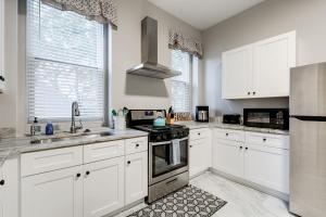 a kitchen with white cabinets and a stove top oven at E1 Centrally located in Carytown fully fenced in Richmond