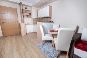 a small room with a table and chairs and a door at Apartman Jula 122 in Zlatibor