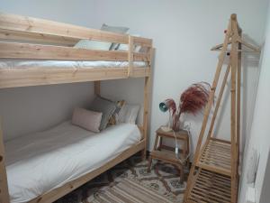 a room with two bunk beds and a ladder at Feel Welcome Barcelona 10 in Cornellà de Llobregat