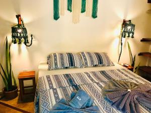 a bedroom with a bed with two pillows on it at Residencial Bem-te-vi in Jericoacoara