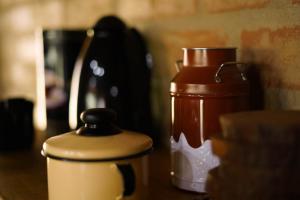 a couple of kettles are sitting on a table at Chalé Vista da Pedra in Gonçalves