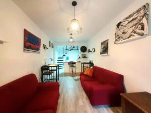 a living room with two red couches and a table at Viejo Hostal B&B in Almería