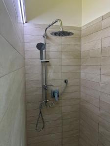 a shower with a shower head in a bathroom at La Casetta in Ordona