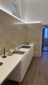 a kitchen with a sink and a counter top at La Casetta in Ordona +19 photos