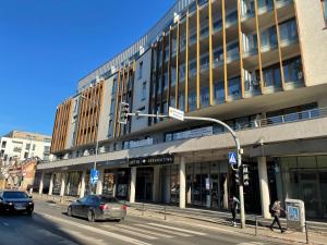 a building on a city street with a traffic light at Garbary 100 CITY CENTER Apartment, free parking, self check-in 24h in Poznań