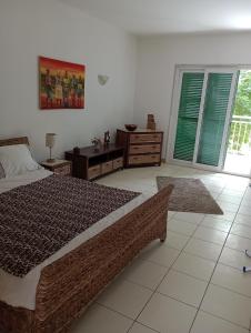 a bedroom with a bed and a table and windows at Surf Beach Vila Verde apartments in Santa Maria +37 photos