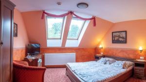 a bedroom with a bed and a window at Rozmann Family Panzió & Apartmanhaz in Sárvár