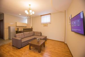 a living room with a couch and a table at Royal Venezia Hotel in Batumi