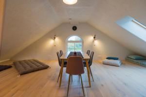 a dining room with a table and chairs in a attic at Apteegimaja Apartment in Rõngu