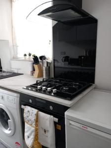 a kitchen with a stove and a washing machine at Affordable Home in Hatfield in Hatfield