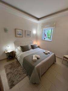 a bedroom with a large bed with two towels on it at Luxury Apartment Spa "Marina" in Makarska