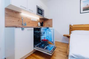 a small kitchen with a glass door refrigerator at Horský apartmán Temari 10 Klínovec in Loučná pod Klínovcem
