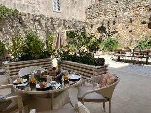a patio with a table and chairs with food on it at Luxury Apartment Spa "Marina" in Makarska