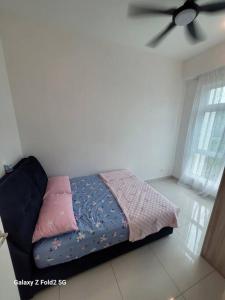 a bed in a room with a ceiling fan at Lee Batu Ferringhi Condominium in Batu Ferringhi