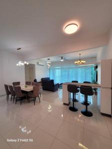 a kitchen and dining room with a table and chairs at Lee Batu Ferringhi Condominium in Batu Ferringhi