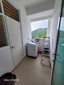 a small room with a view of a balcony at Lee Batu Ferringhi Condominium in Batu Ferringhi