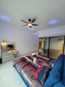 a bedroom with a bed and a ceiling fan at Lee Batu Ferringhi Condominium in Batu Ferringhi