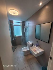a bathroom with a shower and a toilet and a sink at Lee Batu Ferringhi Condominium in Batu Ferringhi