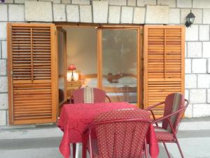 a table and chairs with a red table cloth at Motel Jelčić in Čapljina