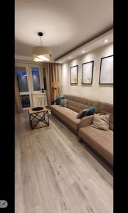 a living room with a couch and a table at Apartament Przemyślany in Przemyśl
