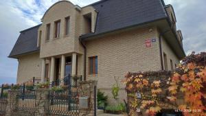 a large brick house with a black roof at Villa Homestay Nad Helmrovkou in Prague