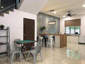 a kitchen and dining room with a table and chairs at G-Homestay @ Sungai Abong Muar*10~20pax in Muar