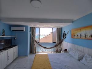1 dormitorio con una hamaca colgada de la pared en Atlântico Flat -207- Vista ao Mar e Pé na Areia, en Natal