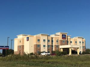 a large building with a car parked in front of it at Hometown Executive Suites in Bridgeport