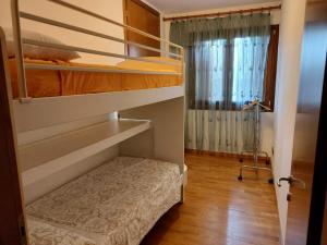 a room with two bunk beds and a window at La Casa di M : D M. in Breda di Piave