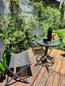 un tavolo e due sedie su una terrazza di legno di Casa 2 ambientes en Tesei, Hurlingham a Morón