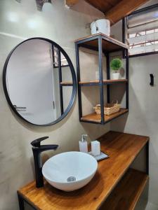 a bathroom with a sink and a mirror on a counter at Casa 2 ambientes en Tesei, Hurlingham in Morón