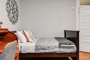 a bedroom with a bed and a dresser at Centrally located in Carytown fully fenced in Richmond +15 photos