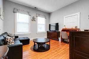a living room with a couch and a table and a piano at E2 Centrally located in Carytown fully fenced in Richmond